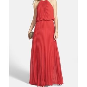 XSCAPE 2P Red pleated gown. Sheer overlay. Gold tone mesh/rope halter. EUC